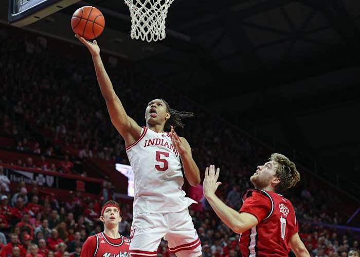 Indiana Hoosiers forward Malik Reneau (5) drives to the basket as Rutgers Scarlet Knights guard Cam Spencer (10) and guard Paul Mulcahy (4) defends during the first half at Jersey Mike's Arena.
